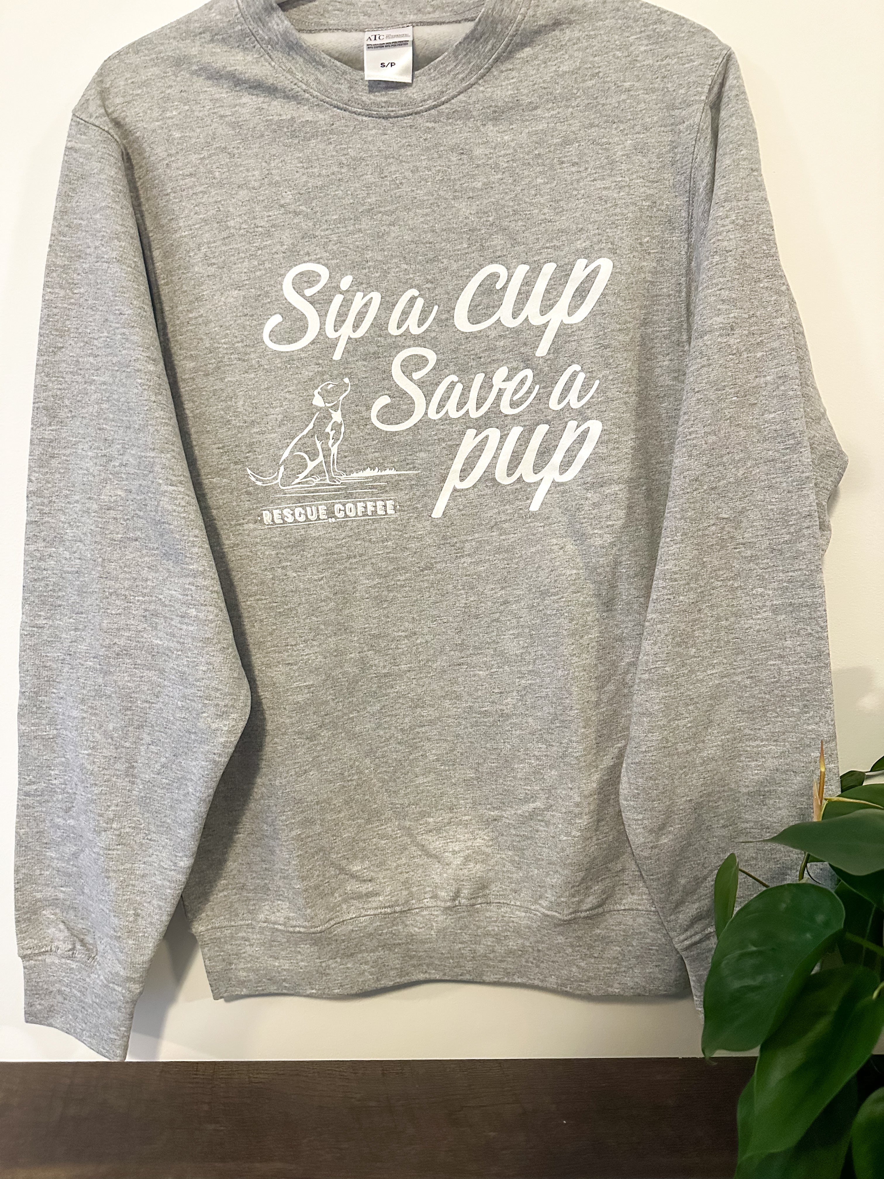 Grey Rescue Coffee Branded Crewneck with slogan "Sip a Cup, Save a Pup"