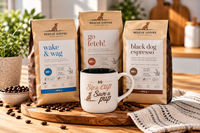 Three bags of Rescue Coffee dog coffee in different flavors (wake & wag, go fetch!, black dog espresso) arranged on a wooden board with a white ceramic mug that says ' Sip a cup Save a pup' and scattered coffee beans.