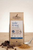 Rescue Coffee 'Wake & Wag' package on a wooden surface with coffee beans and chocolate.